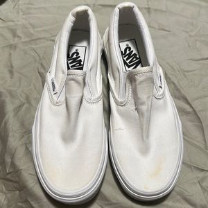 All white slip on vans.